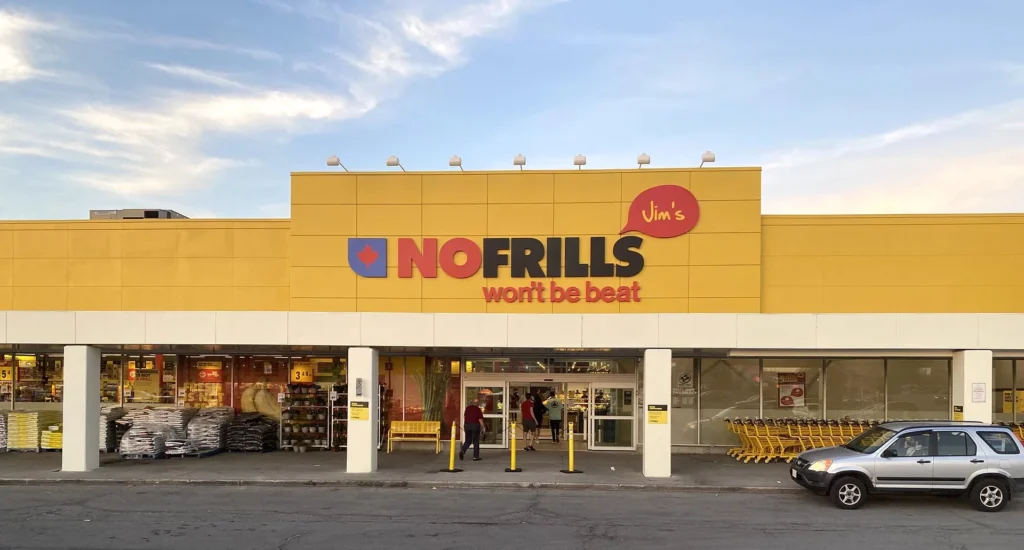 Aluminum plates with custom colors and certified safety applied to a NOFRILLS retail facade.