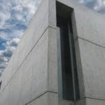 A modern house exterior featuring architectural concrete panel cladding.